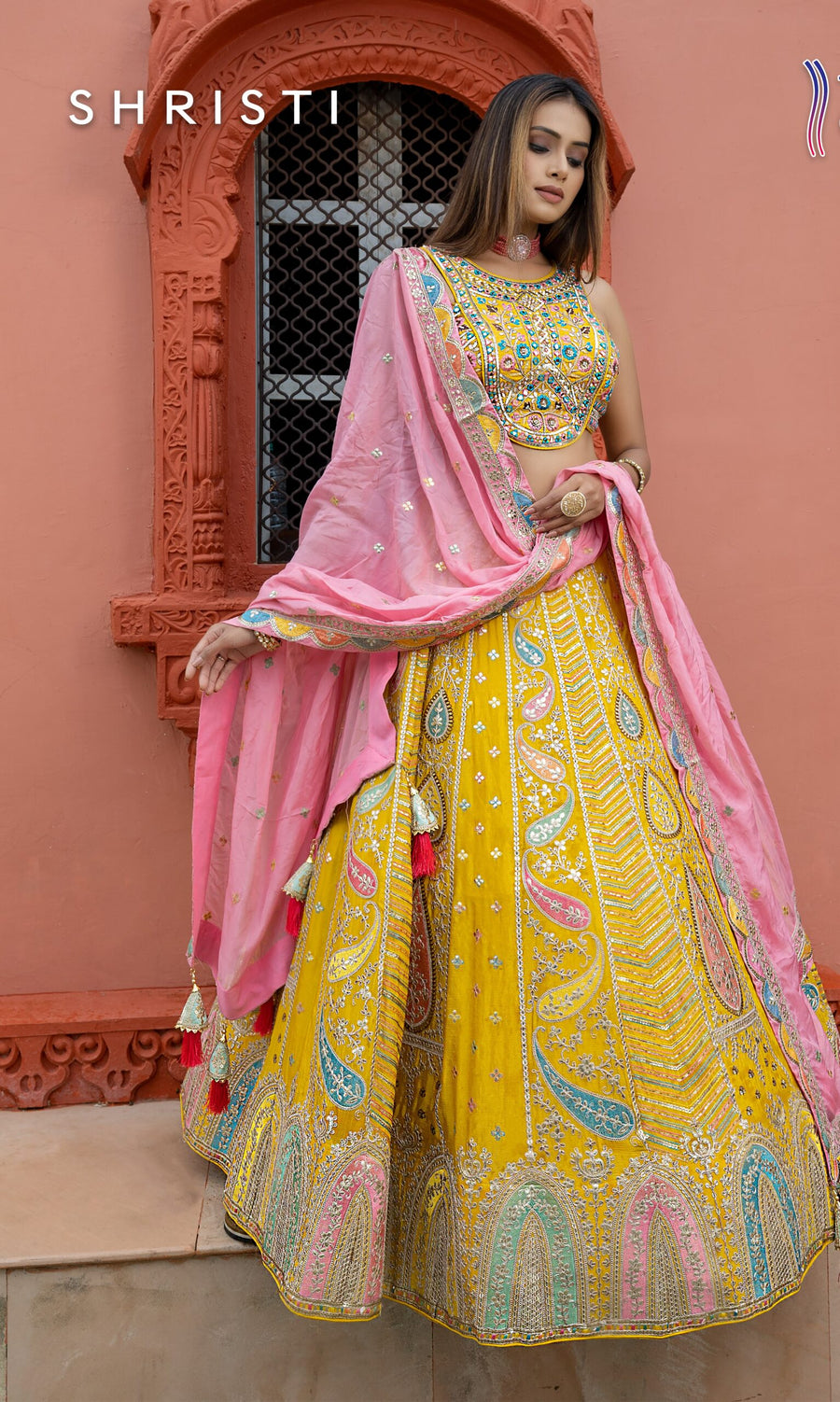 Brighten up your wardrobe with this stunning yellow lehenga set, featuring intricate embroidery that's perfect for weddings and special events.