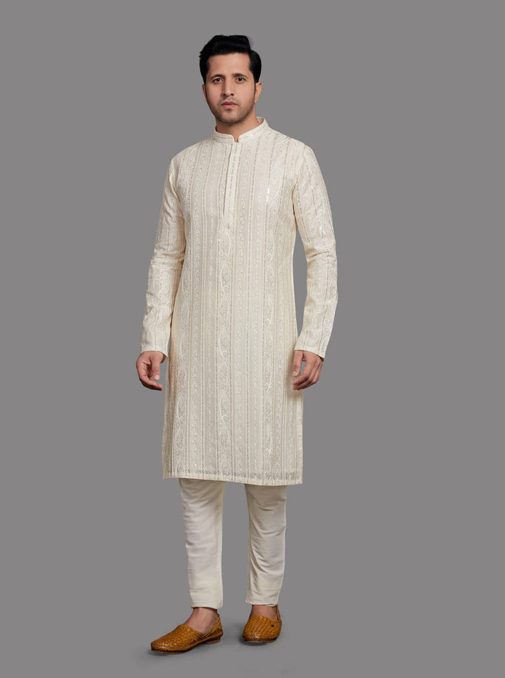 Elegant White Kurta Pajama set for men with traditional embroidery, perfect for weddings.