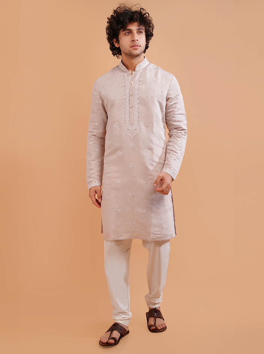 Men's pale pink embroidered kurta pajama set, ideal for weddings and cultural events.