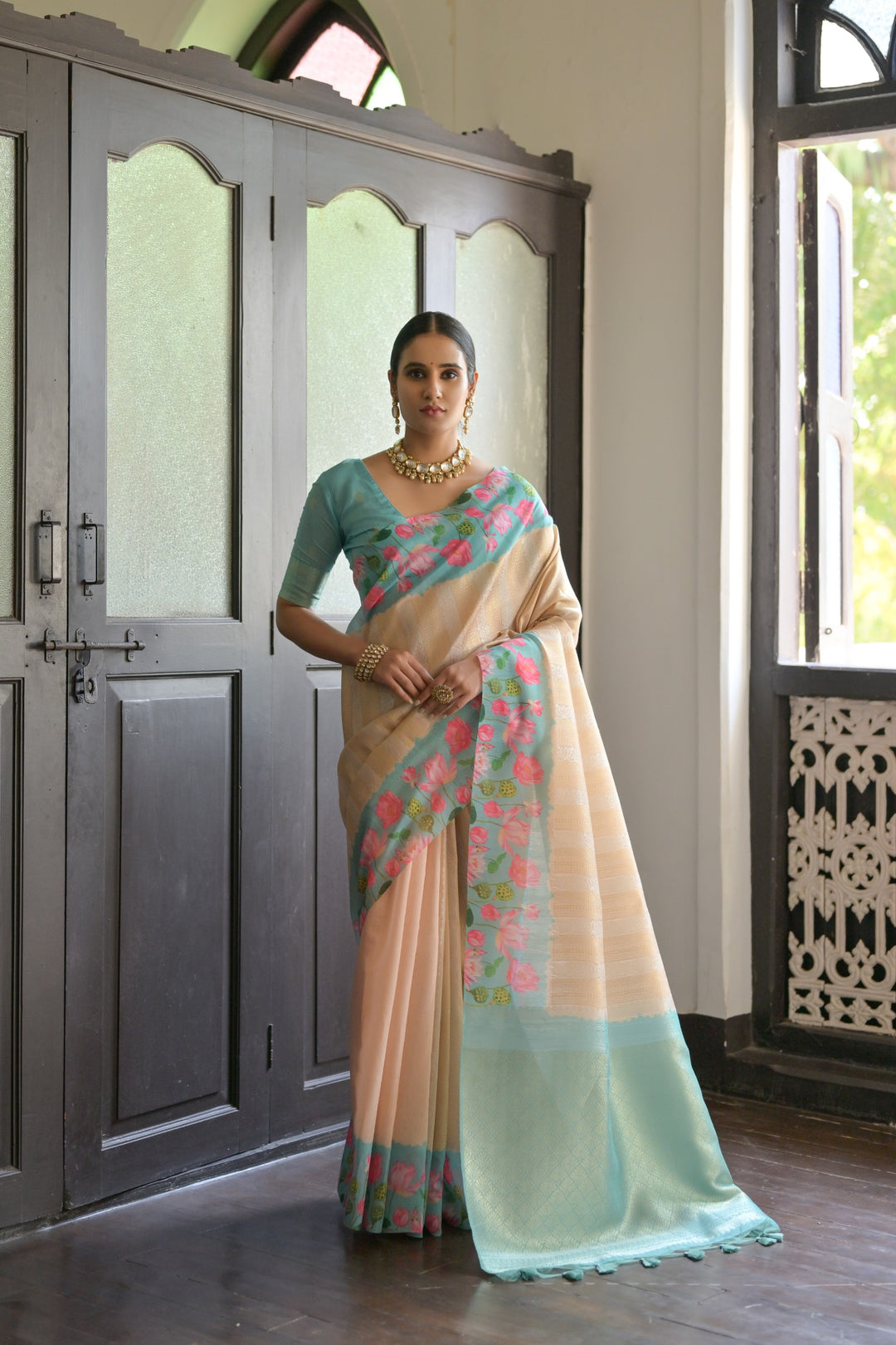 Sky-blue soft silk saree with intricate Pichwai lotus print and luxurious zari pallu, perfect for traditional events.