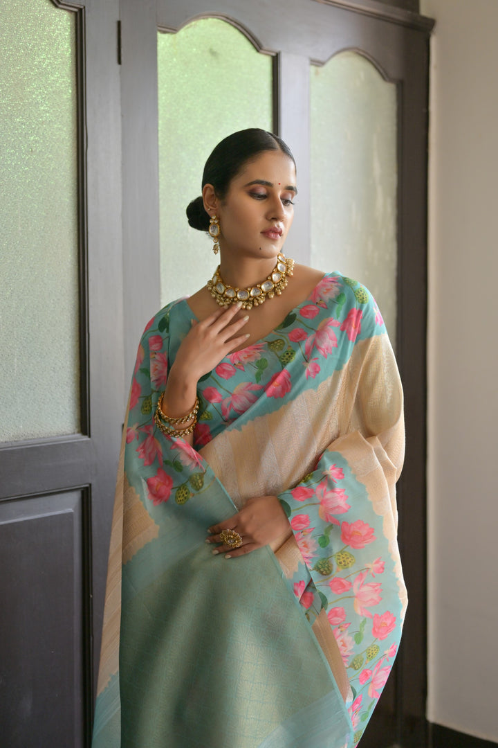 Beautiful sky-blue soft silk saree featuring delicate Pichwai lotus print and elegant zari pallu, ideal for festivals.