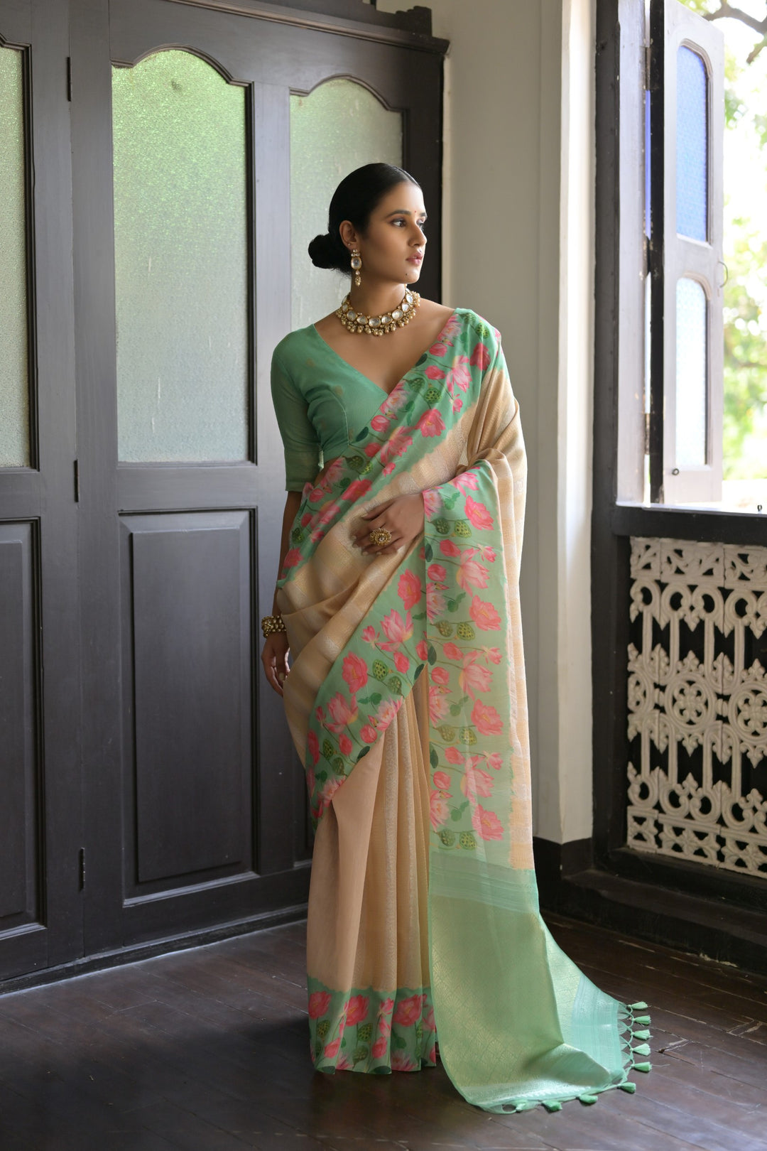 Elegant sky-blue soft silk saree with intricate lotus print and ornate zari pallu, ideal for bridal wear.