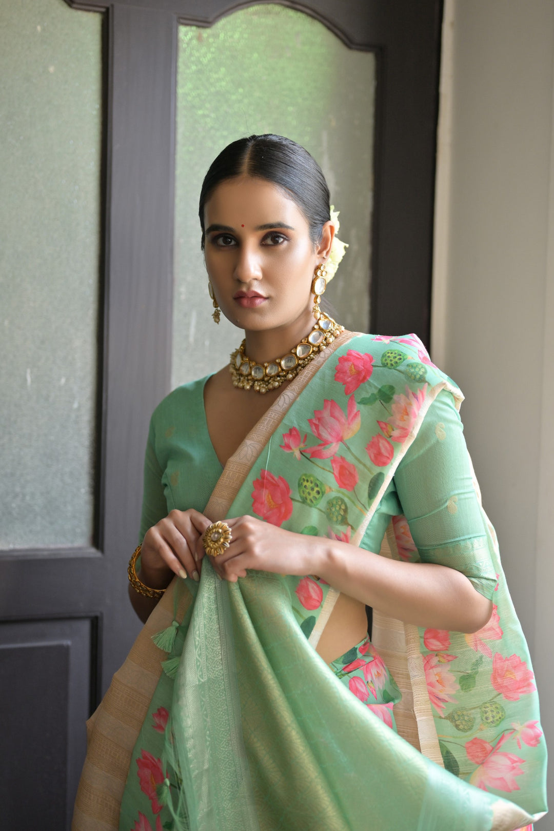 Lovely light-green soft silk saree with detailed Pichwai lotus print and luxurious zari pallu, ideal for traditional ceremonies.