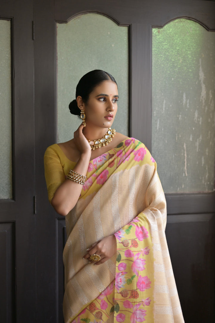 Gorgeous coral-orange soft silk saree with Pichwai lotus print and elegant zari pallu, perfect for traditional events.