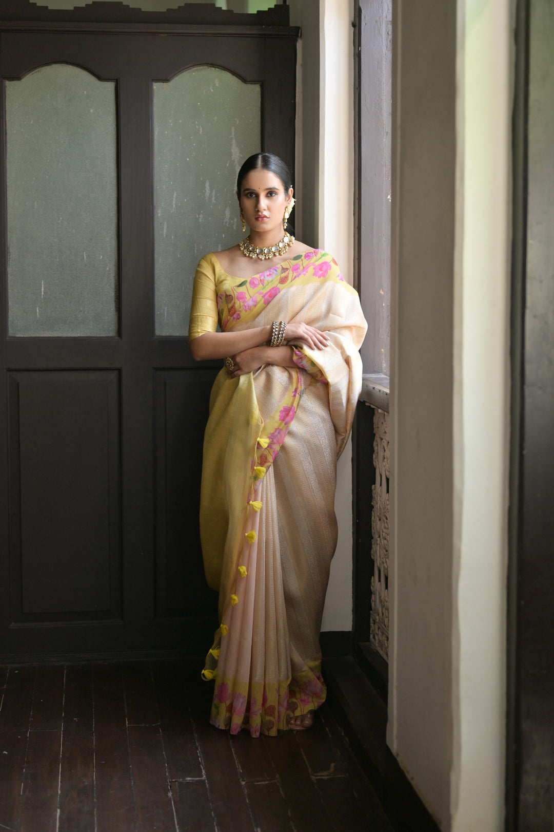 Beautiful coral-orange soft silk saree with intricate Pichwai lotus print and rich zari pallu, ideal for cultural occasions.