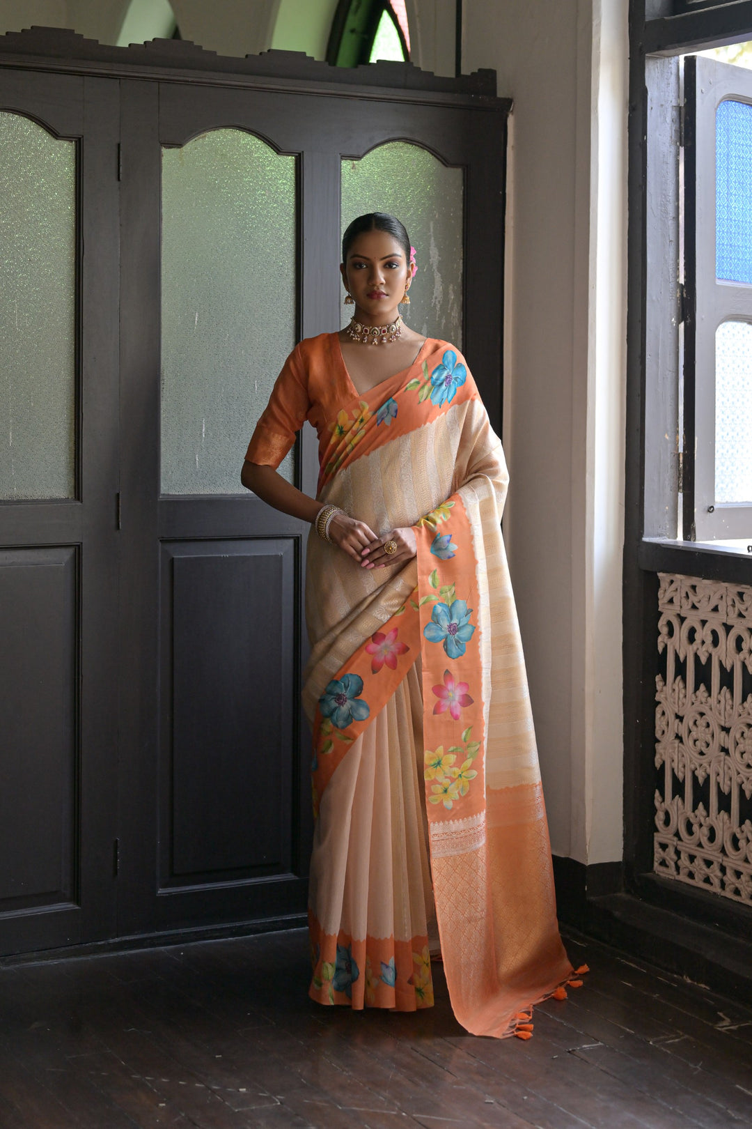 Graceful sky-blue silk saree featuring floral prints and an exquisite lotus pattern on the pallu, perfect for festive wear.