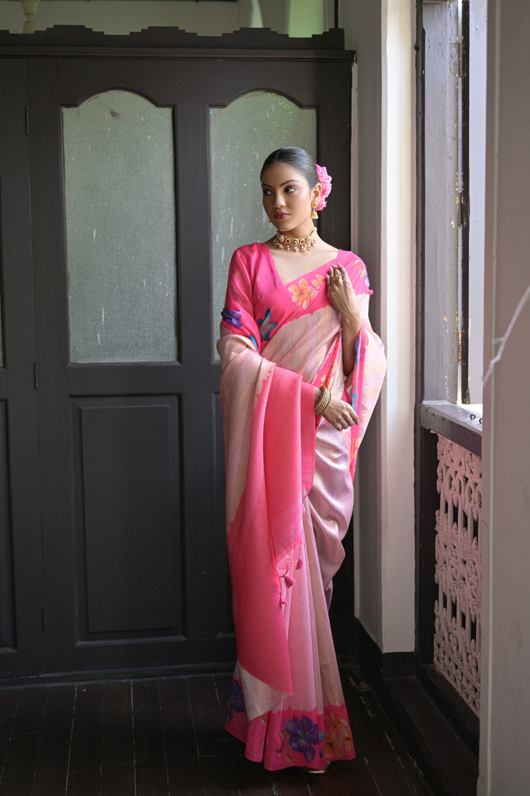 Beautiful orange silk saree with floral prints and a fancy lotus pattern pallu, perfect for cultural events.