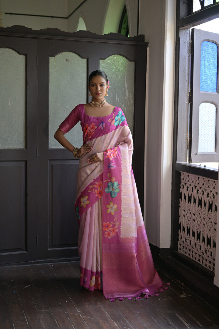 Charming pink silk saree featuring floral prints and an exquisite lotus pattern on the pallu, perfect for a traditional look.