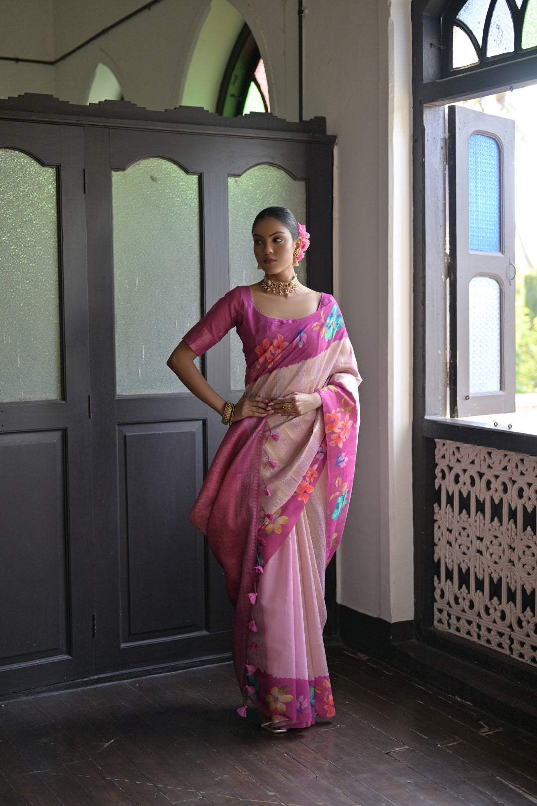 Lovely pink silk saree with intricate flower prints and an elegant lotus pattern pallu, perfect for making a statement.