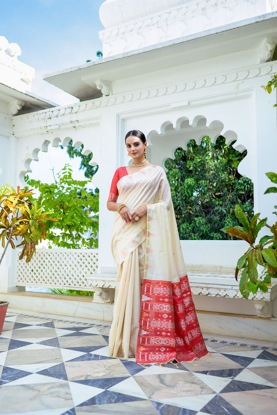 Elegant off-white Tussar silk saree with unique temple border and fancy Ikkat pallu, perfect for festive occasions.