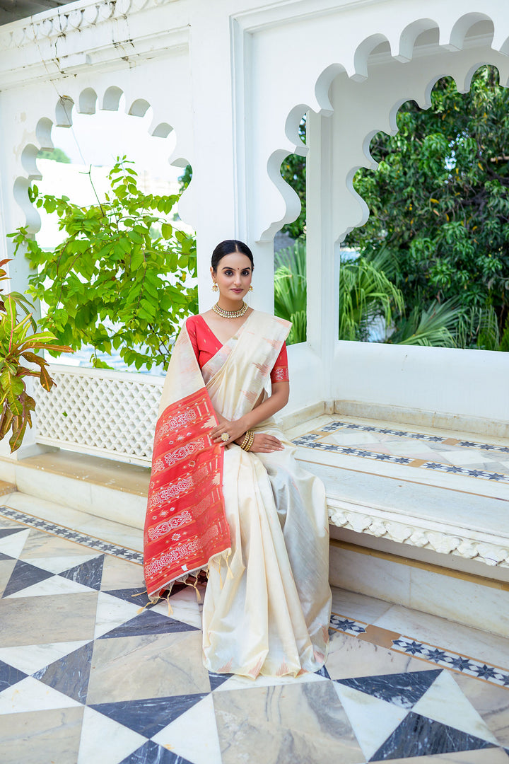 Timeless off-white Tussar silk saree featuring intricate temple border and an elegant Ikkat pallu design.