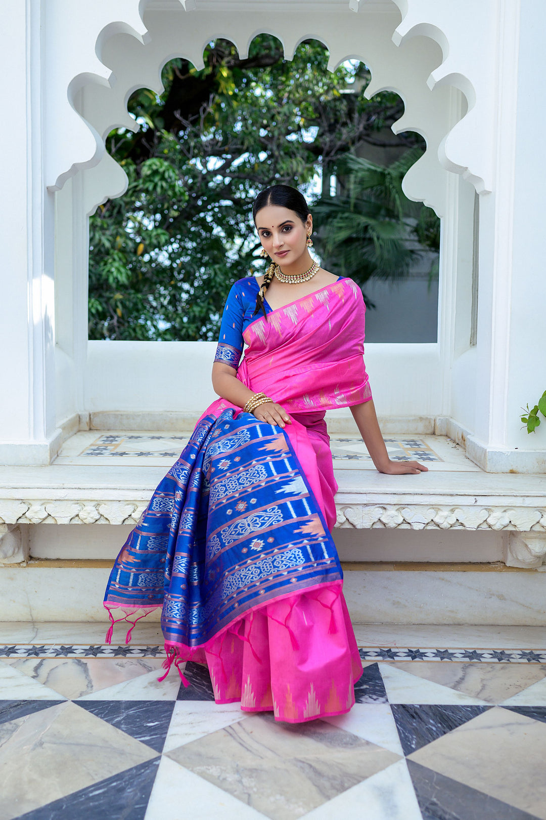 Stylish pink Tussar silk saree with an elegant temple border and fancy Ikkat pallu, perfect for formal gatherings.