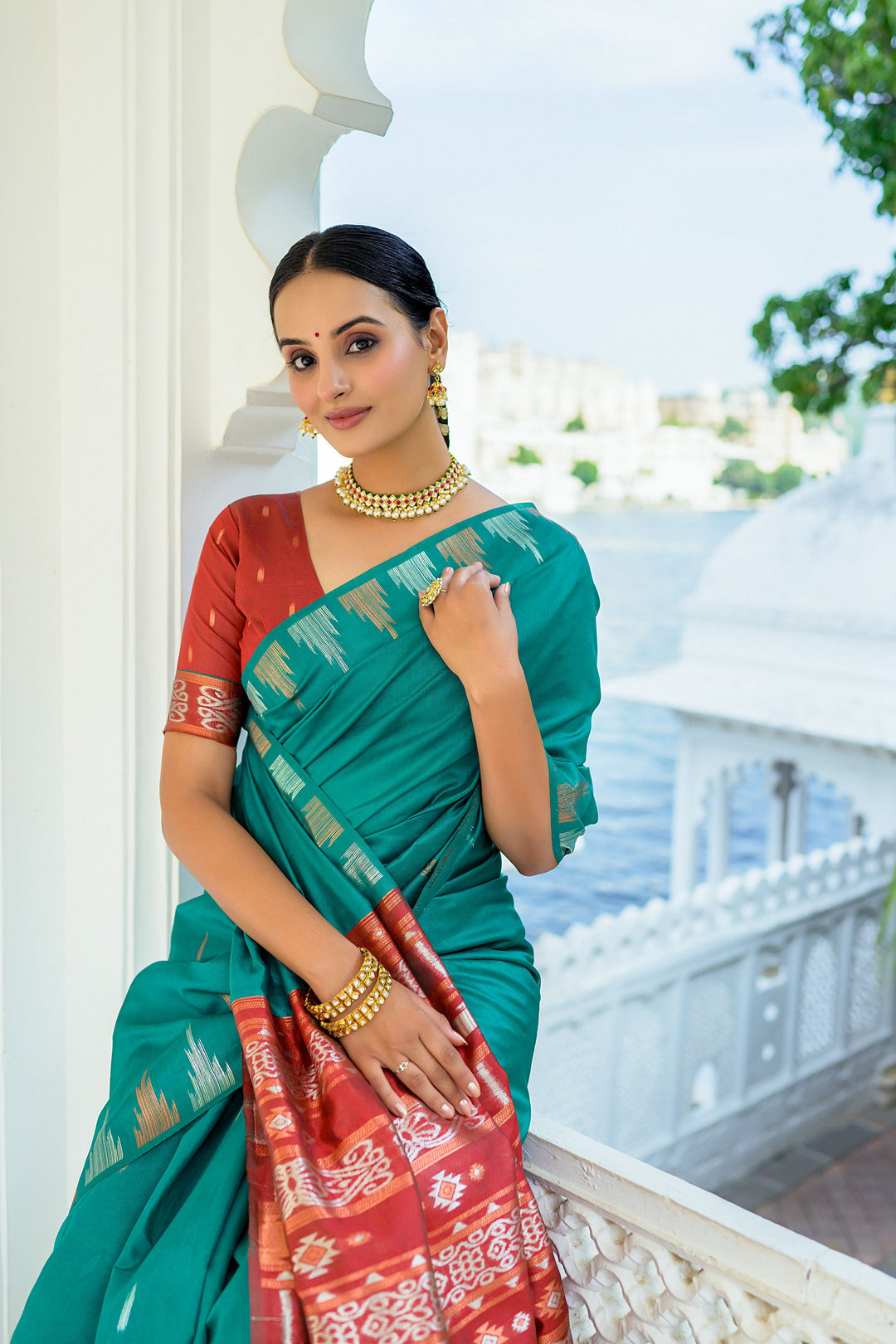 Vibrant pink Tussar silk saree with a unique temple border and colorful Ikkat pallu design, perfect for festivals.