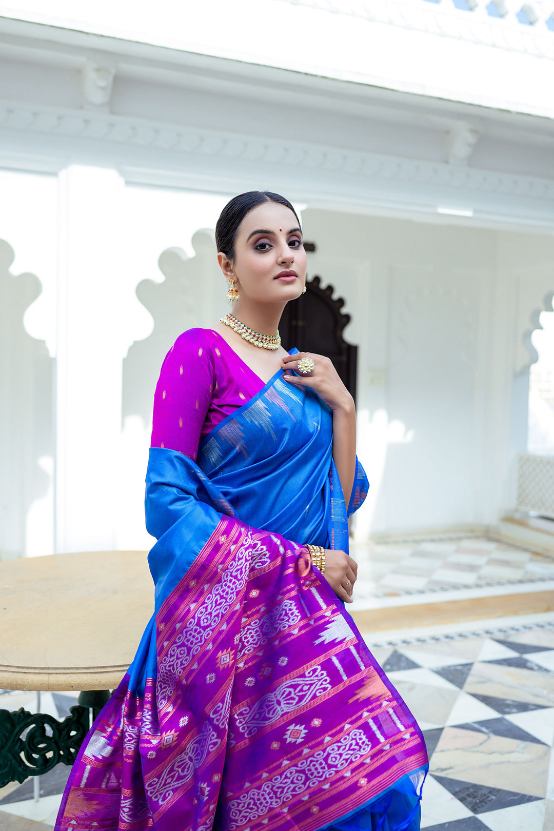 Elegant red Tussar silk saree with a unique temple border and Ikkat pallu design, perfect for festive events.