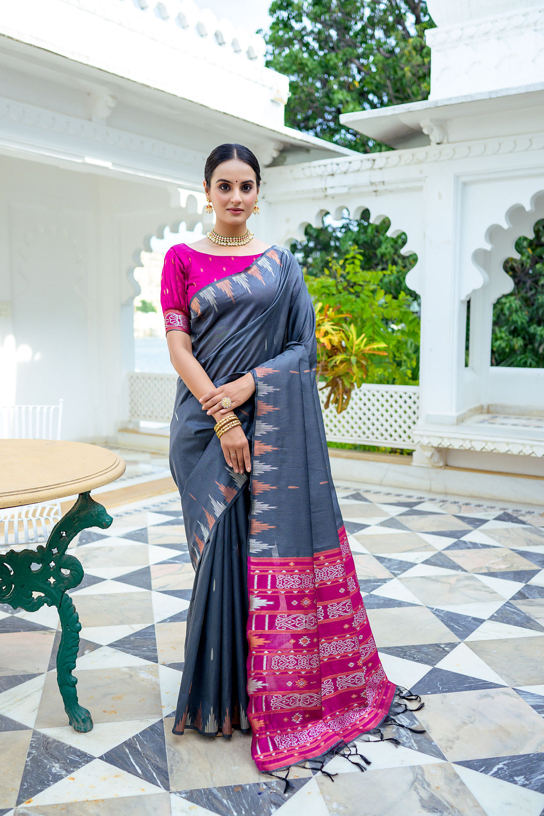 Gorgeous red Tussar silk saree with bold temple border and colorful Ikkat pallu, ideal for traditional ceremonies.