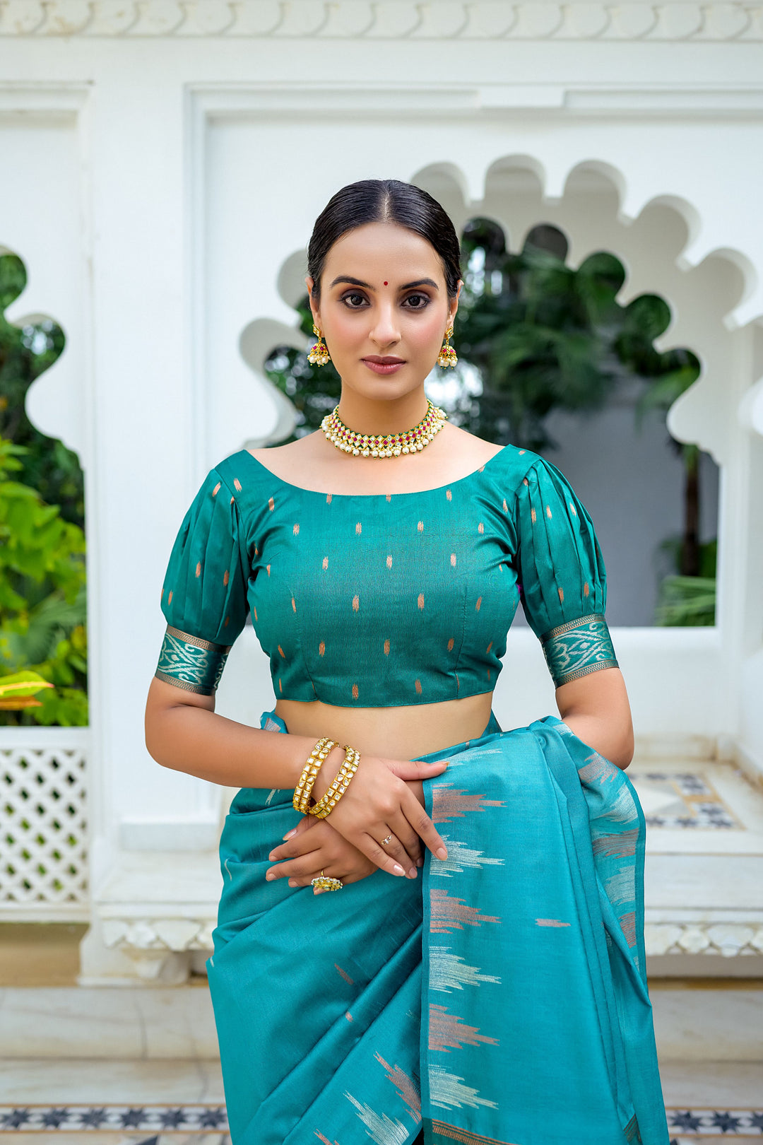 Chic blue Tussar silk saree with a beautiful temple border and vibrant Ikkat pallu, ideal for formal gatherings.