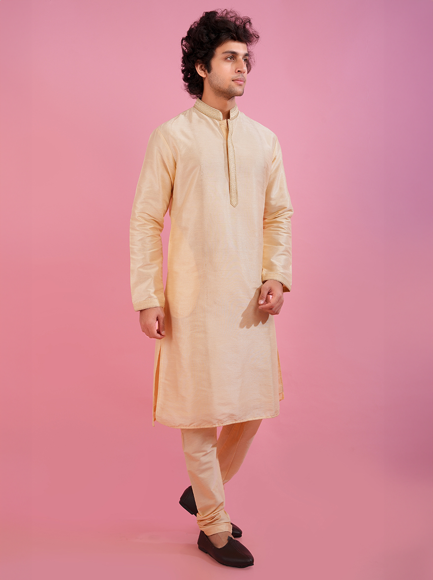 Light gold kurta pajama set for men with elegant embroidery, ideal for cultural celebrations.