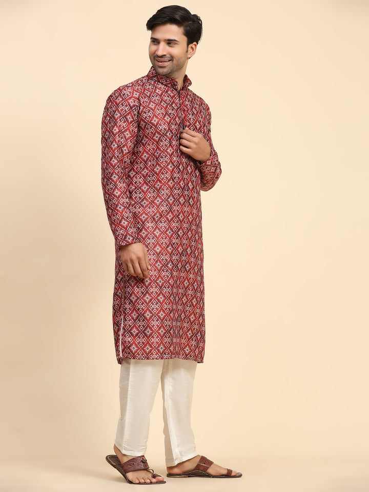 Bold red kurta for men with geometric print, paired with cream silk pyjama for celebrations.