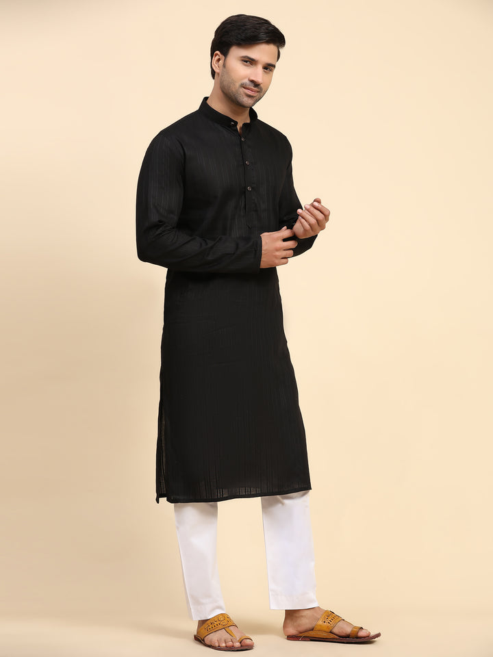 Black kurta pajama set for men with elaborate embroidery, ideal for festivals and grand occasions, blending tradition and modern style.
