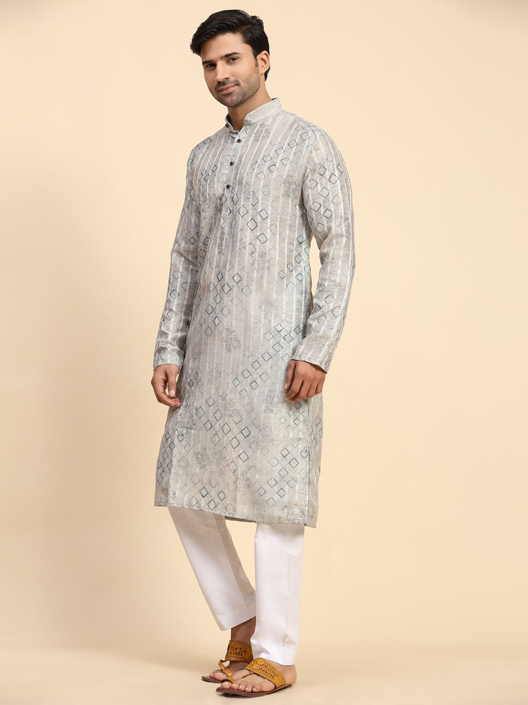 Grey kurta pajama set for men with sleek silhouette and geometric designs.