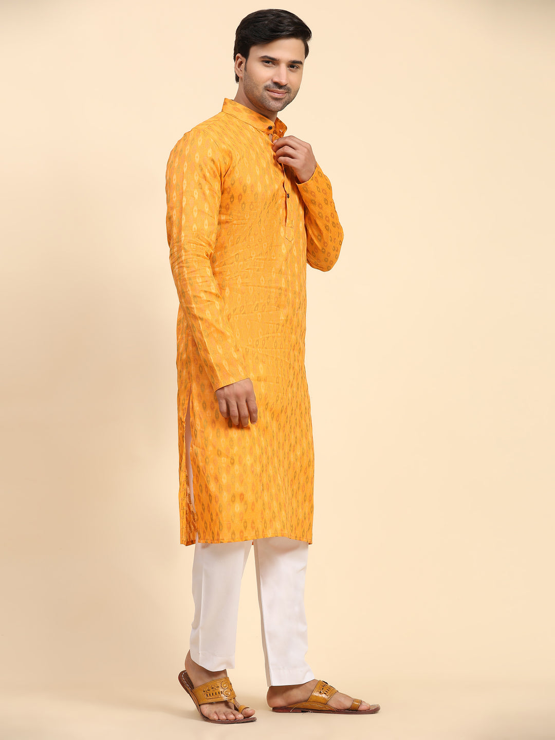 Handcrafted light orange kurta set with intricate motifs for festive wear.