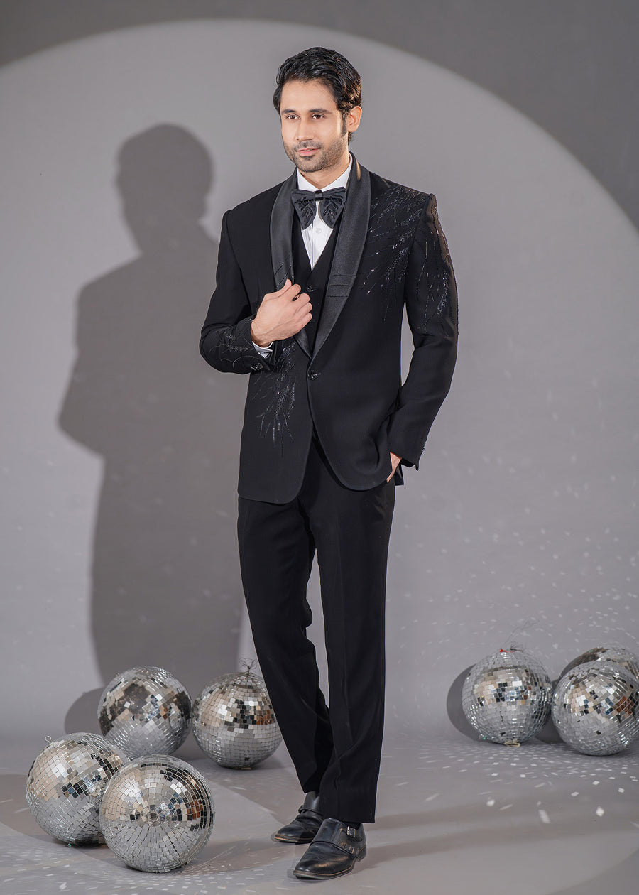 Elegant black tuxedo with asymmetrical cut and stardust-inspired Dana work, perfect for formal occasions.