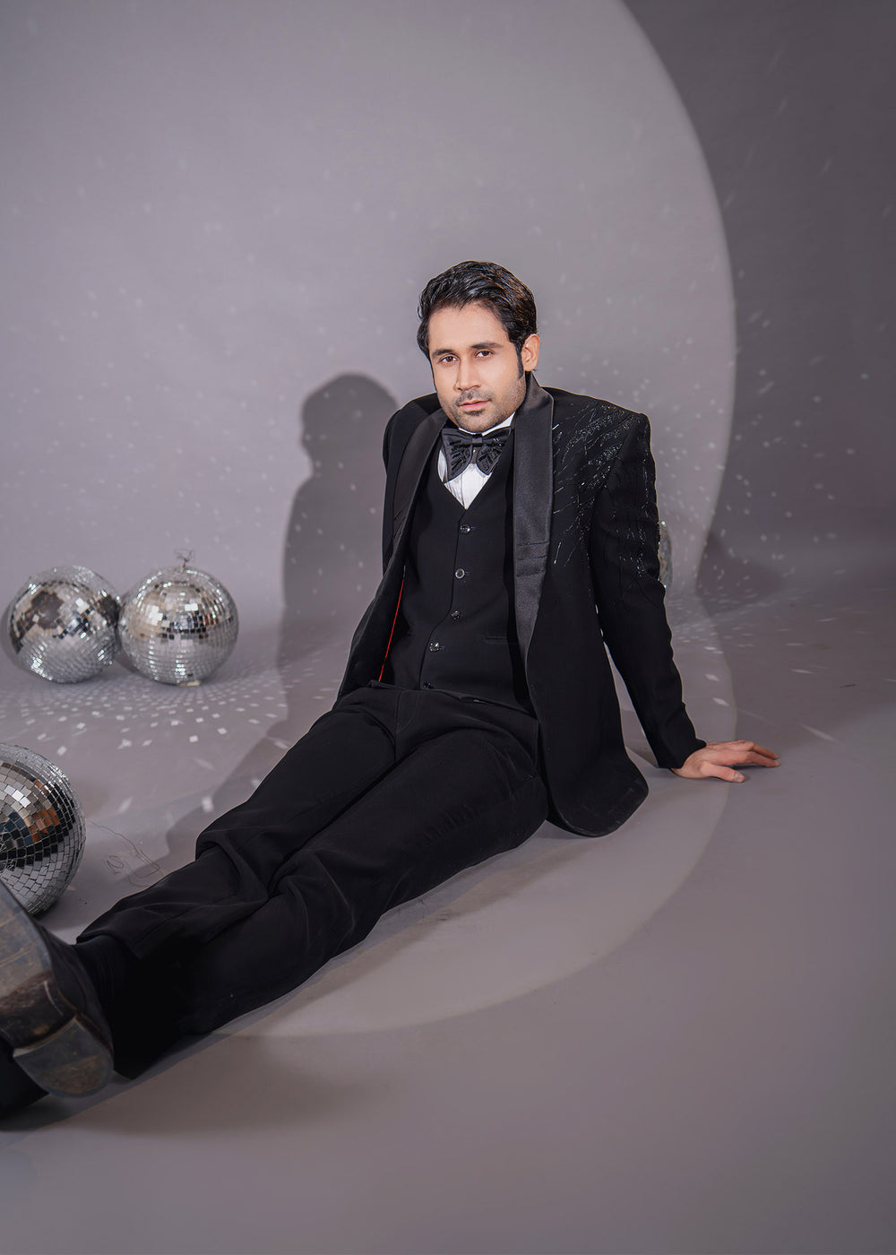 Men's black tuxedo with asymmetrical design and Dana work, offering a timeless, sophisticated look for formal events.