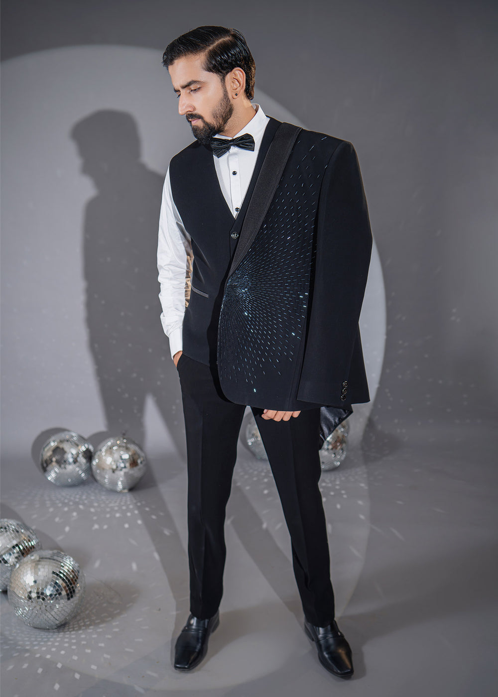 Opulent black tuxedo featuring intricate Cutdana detailing, perfect for making a statement at weddings and formal events.