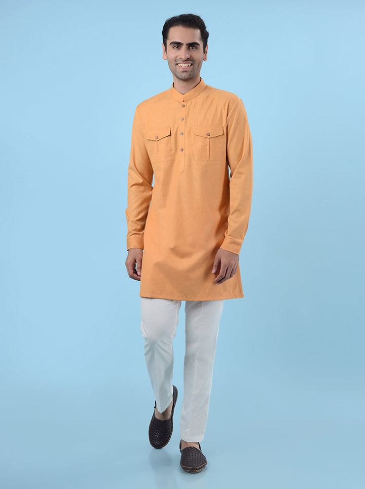 Orange silk kurta pajama set for men, featuring fine embroidery for a luxurious ethnic look.