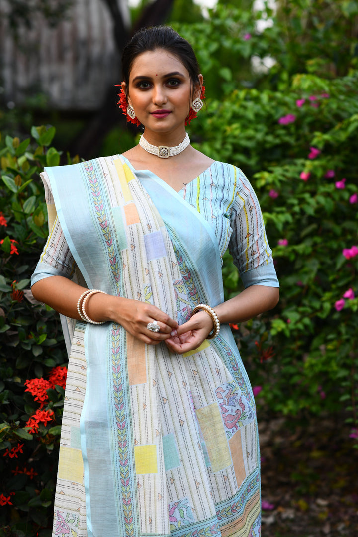 Beautiful sky-blue designer linen saree with intricate floral pallu, ideal for casual events and traditional wear.