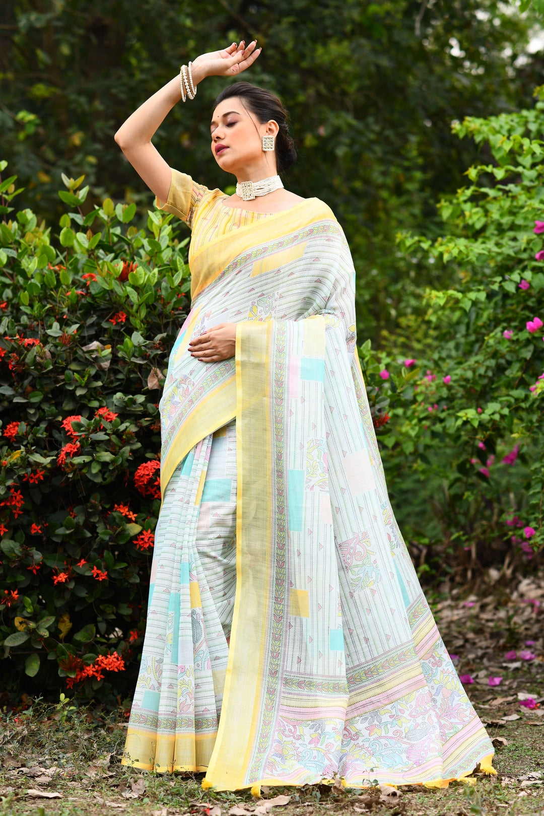 Timeless sky-blue linen saree with floral pallu detailing, offering a fresh and vibrant look for festive events.