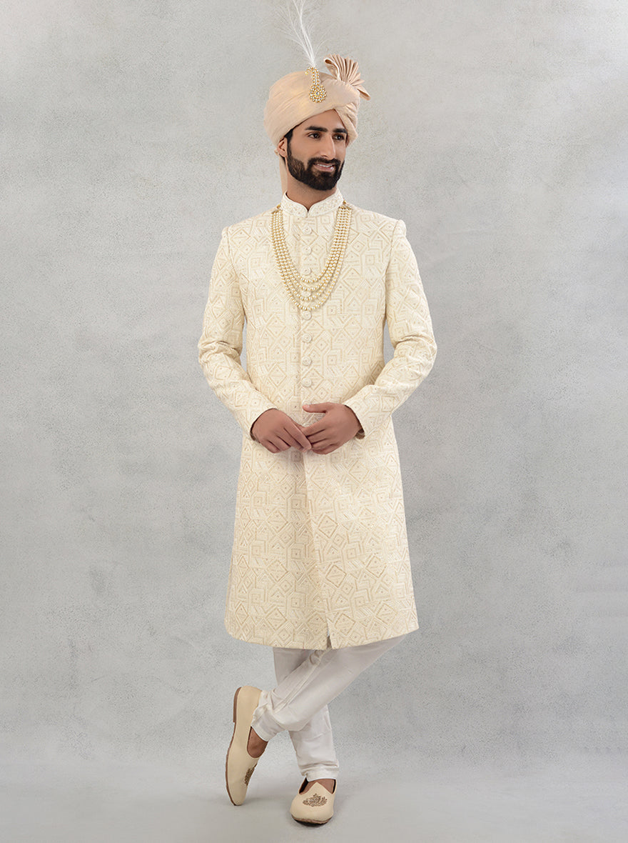 A perfect blend of tradition and modern style, this cream sherwani is a must-have for your special day.