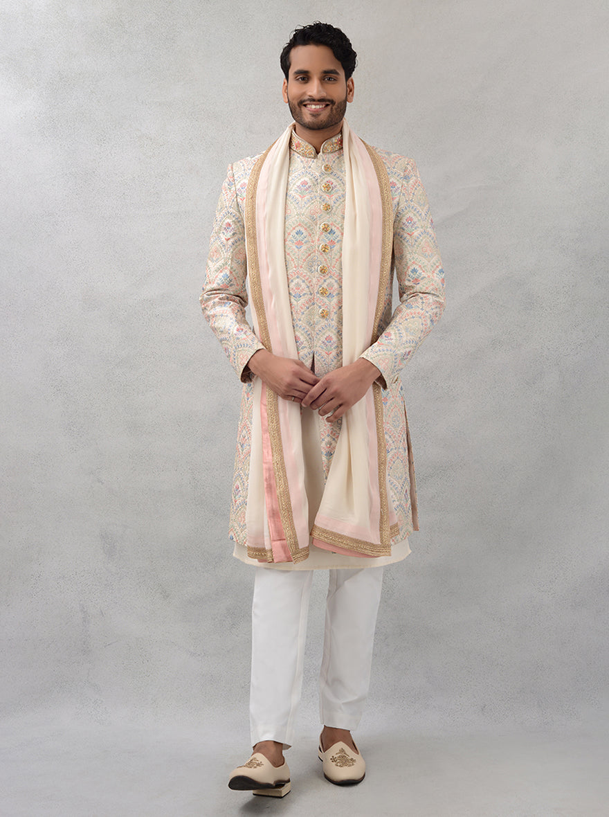 Make a lasting impression in this elegant cream silk blend sherwani, featuring stunning embroidery for a classic yet modern look at special events.