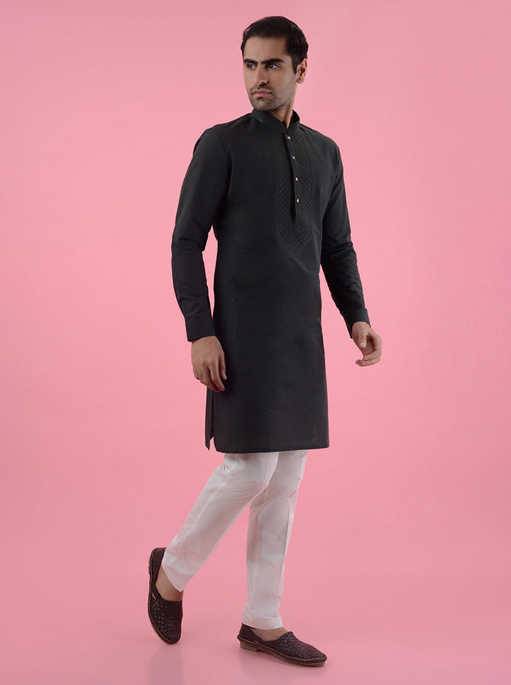 Men's cotton blend dark green kurta pajama set with detailed embroidery, ideal for celebrations.