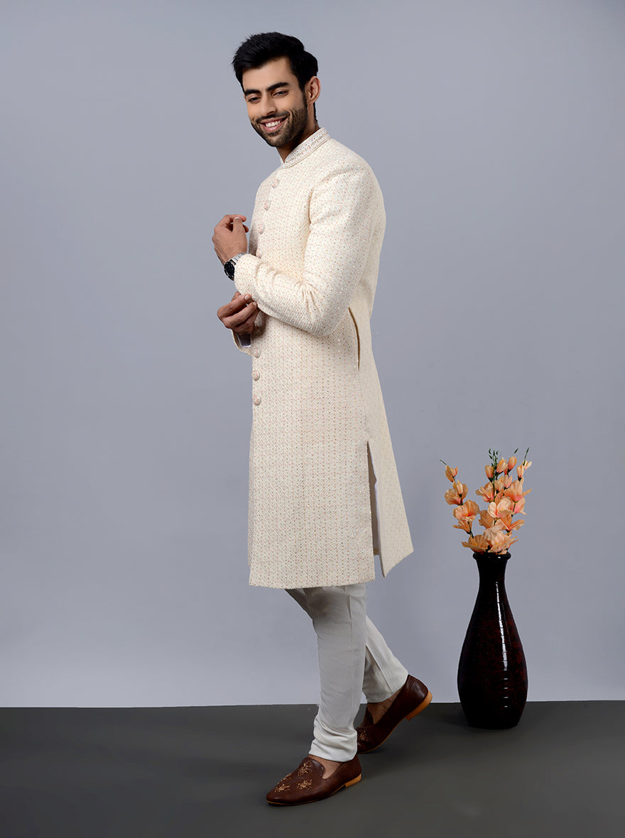 Elegant cream sherwani featuring meticulous hand and machine work, ideal for USA weddings.