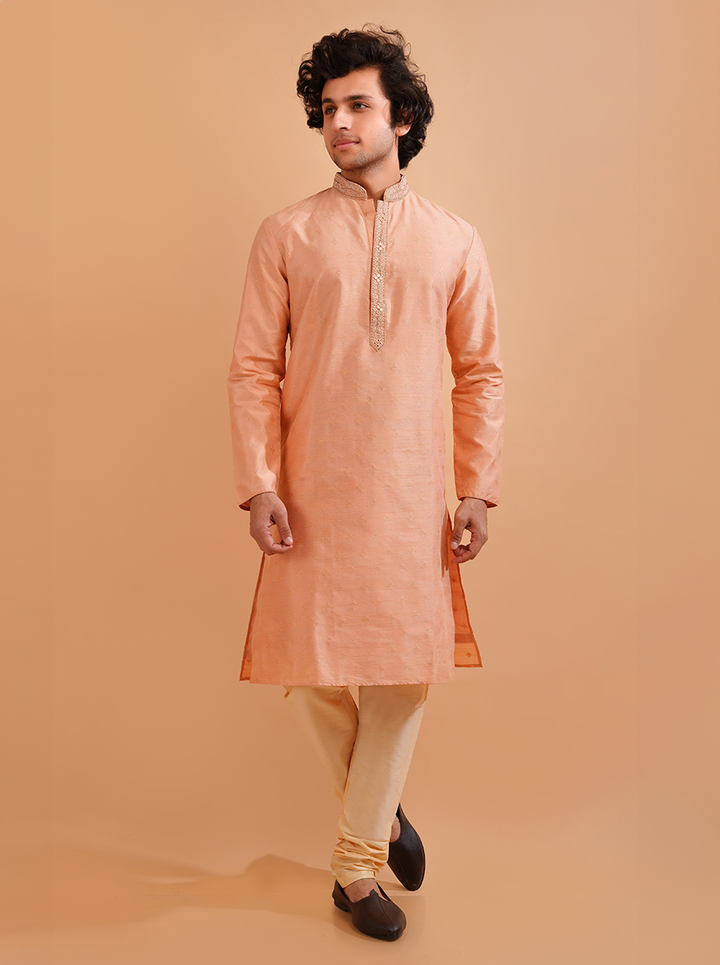 Elevate your festive gatherings with this stylish peach silk kurta pajama, crafted for comfort and elegance.