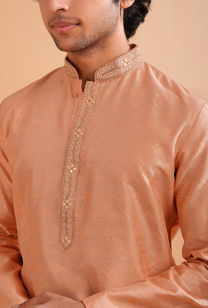 Traditional peach silk jacquard kurta pajama set for men with self-design details.