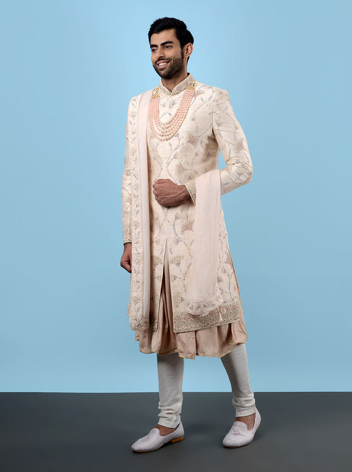 Stylish fawn peach sherwani crafted from raw silk, designed for grooms seeking sophistication.