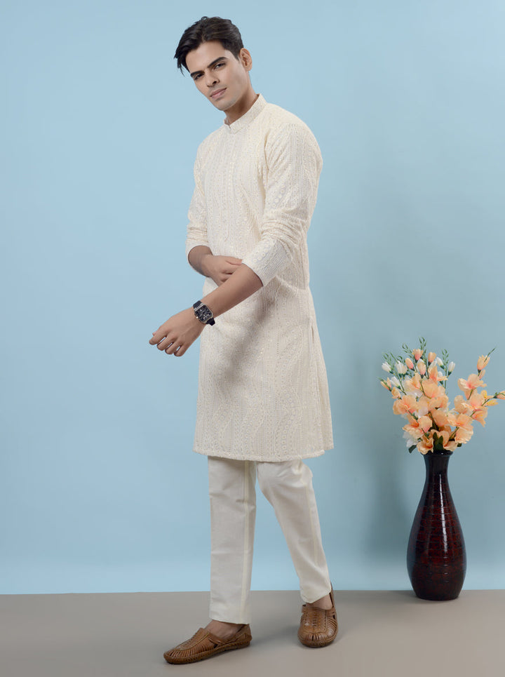 Stunning cream silk kurta pajama featuring intricate embroidery for elegant festive occasions.