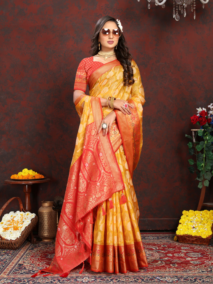 Elegant yellow Organza silk saree with luxurious Meenakari patterns, perfect for weddings.