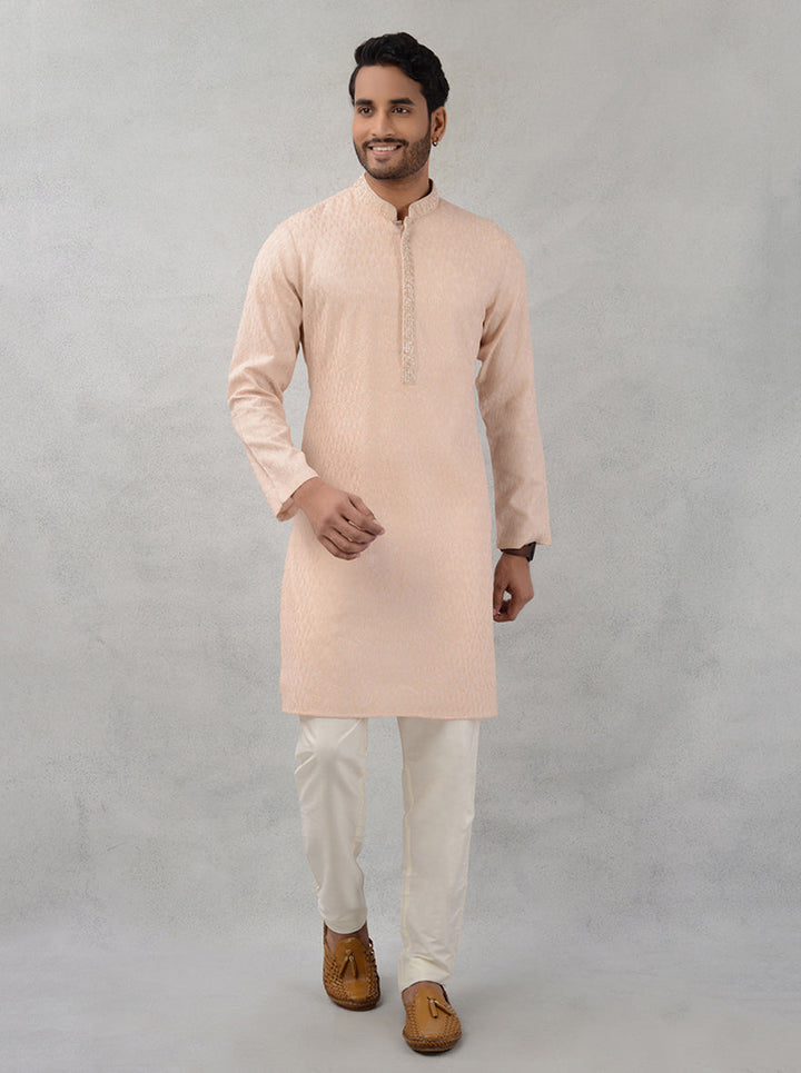 Elevate your ethnic wear with this peach kurta pajama, designed to impress at gatherings.