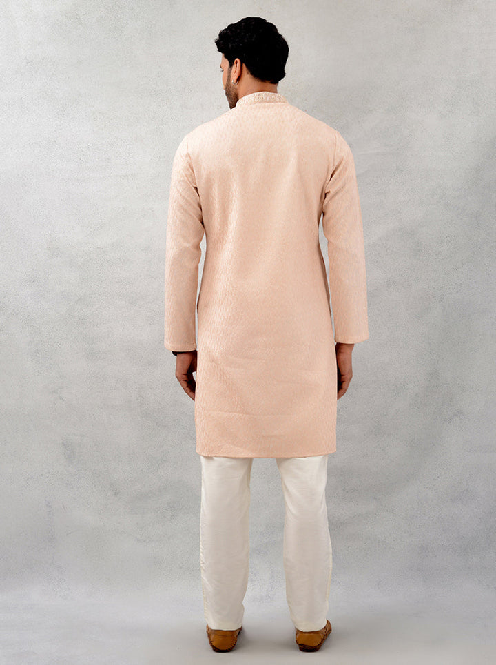 Experience style and comfort in this peach kurta pajama, perfect for festive celebrations.