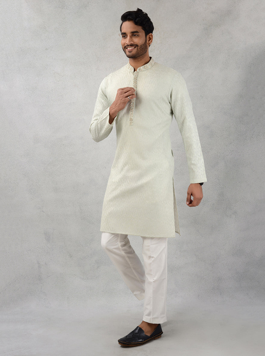 Make a statement in this embroidered pista green kurta pajama for men, perfect for festive occasions.