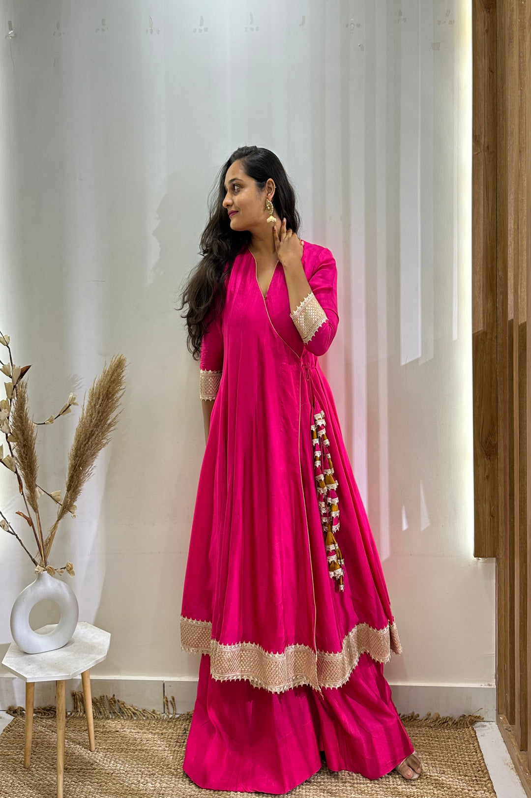 Elegant hot pink Anarkali with Angrakha design, complemented by a contrast tissue dupatta for stylish flair.