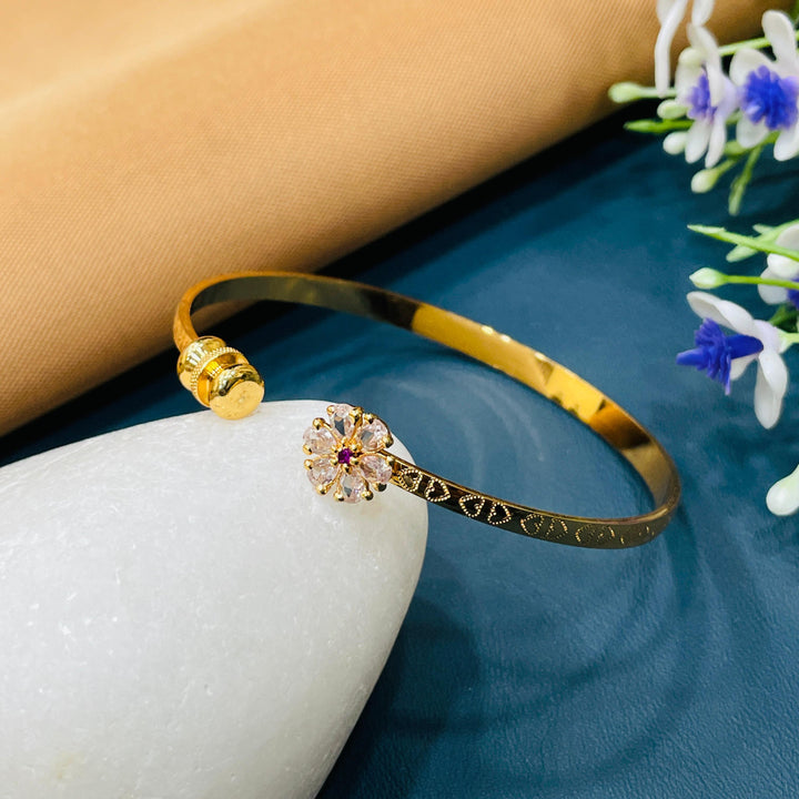 Golden bracelet with intricate detailing and a lustrous finish for added charm.