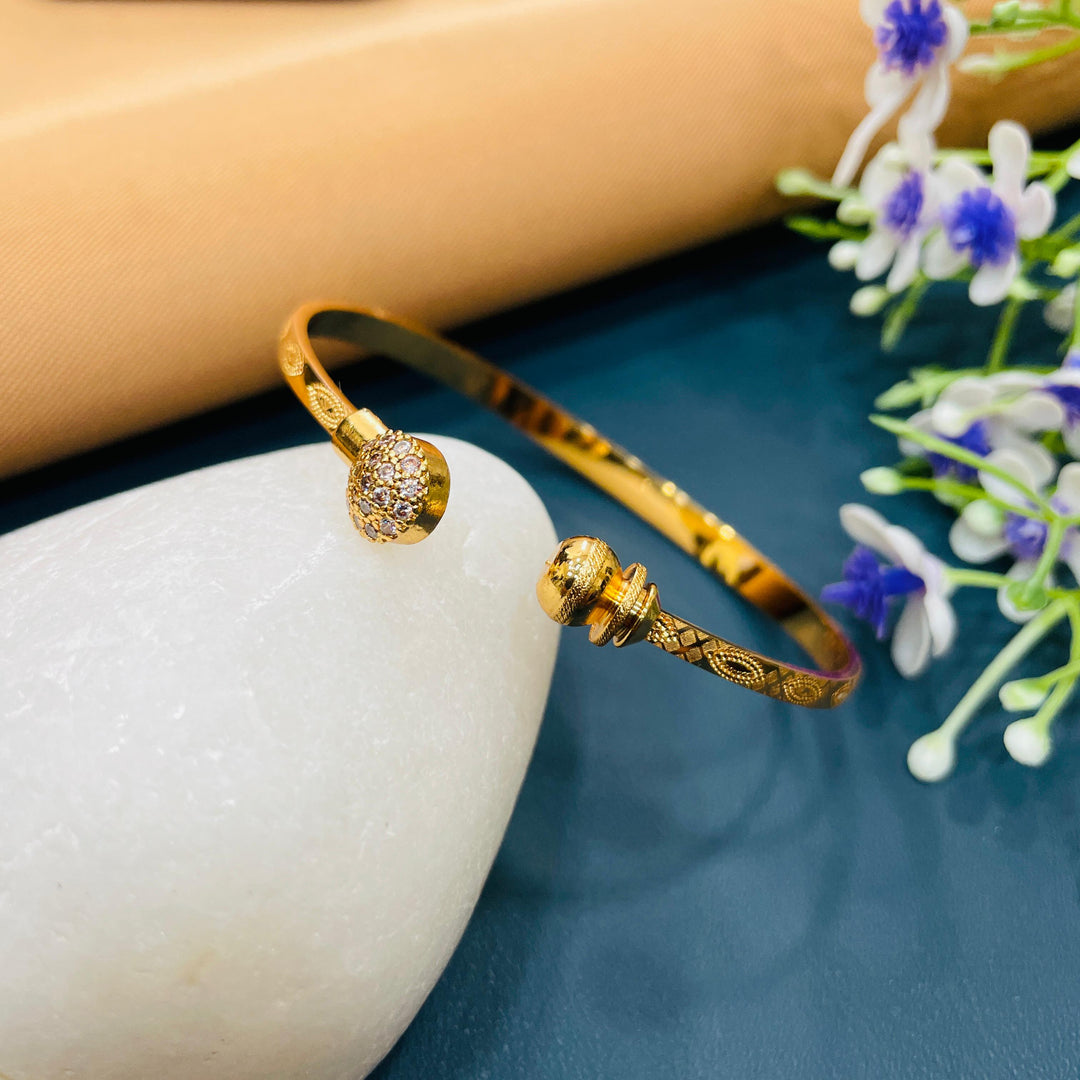 Elegant golden bracelet adorned with delicate charms, ideal for casual looks.