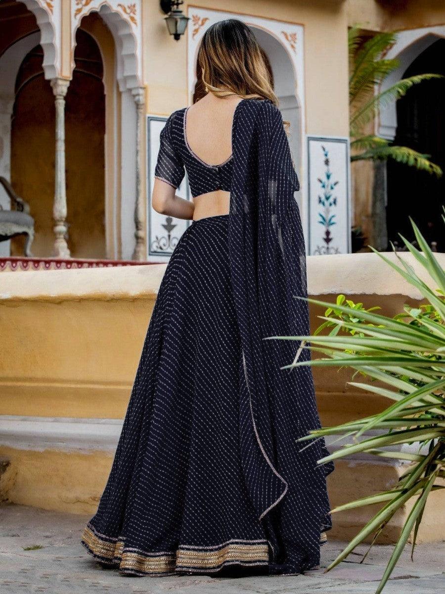 Semi-stitched black lehenga choli with matching dupatta.