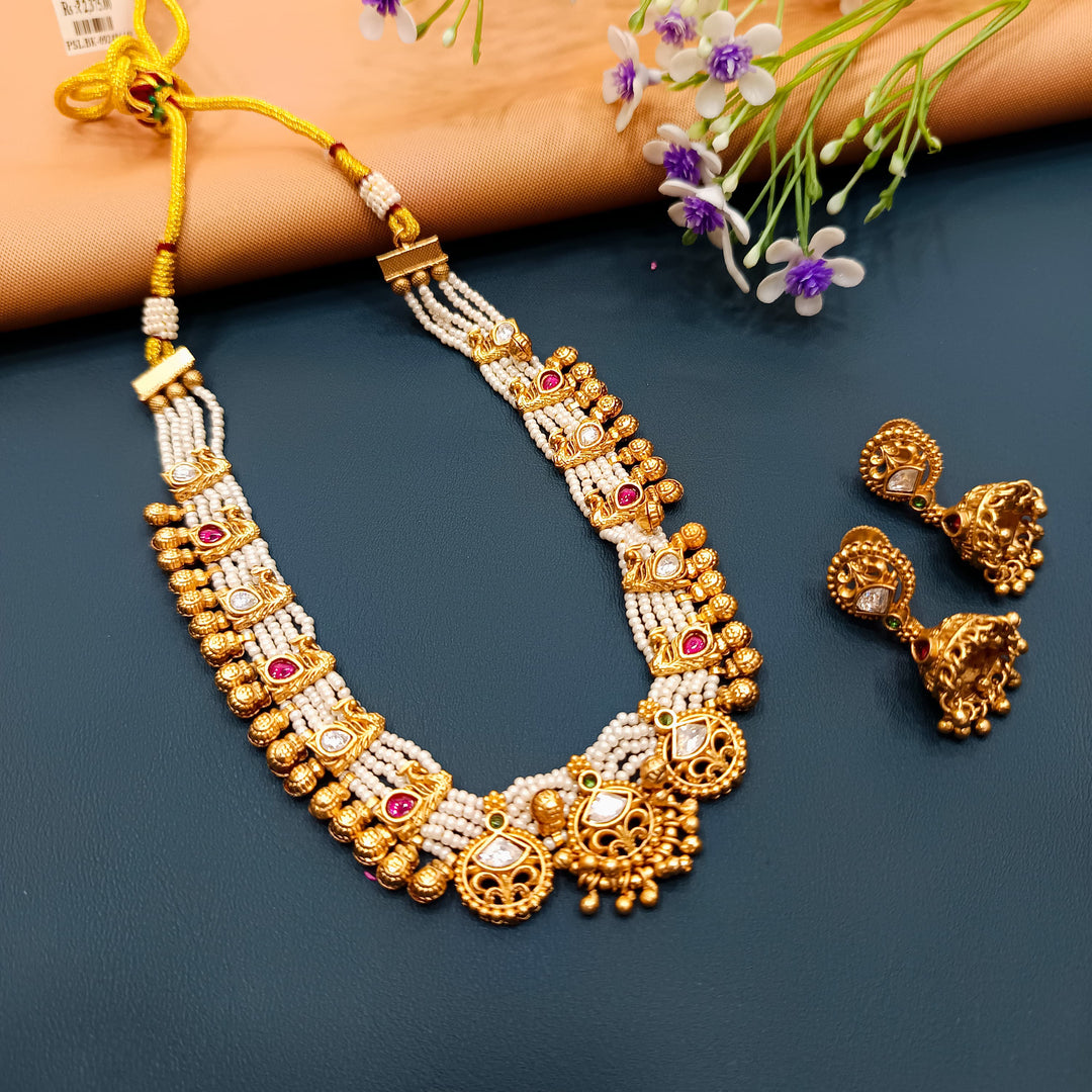 Beautiful Indian choker set in antique gold, a classic choice for traditional celebrations.