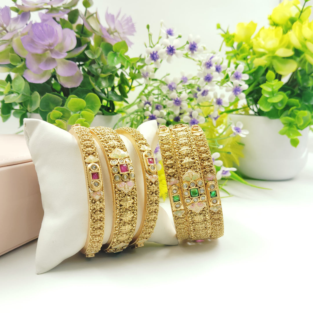 Vibrant golden bangles that complement colorful outfits beautifully.