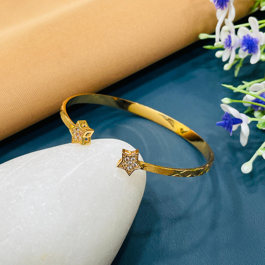 Golden bracelet with a chic, open design, suitable for formal gatherings.